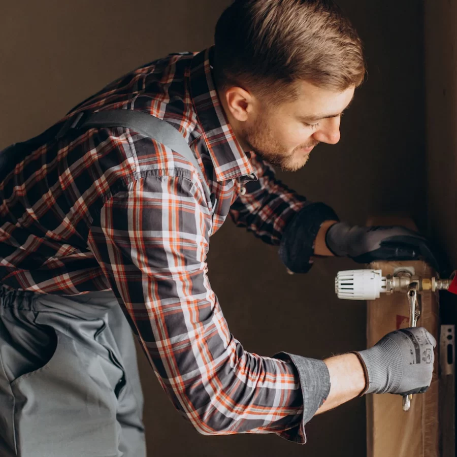 service-man-adjusting-house-heating-system_1303-26535 service-man-adjusting-house-heating-system_1303-26535